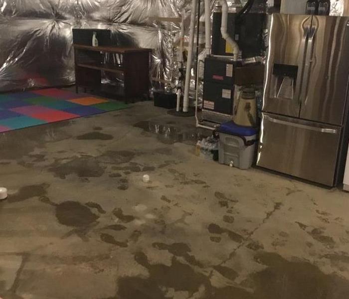 basement with wet concrete floor