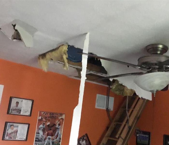 child's bedroom with ceiling damage