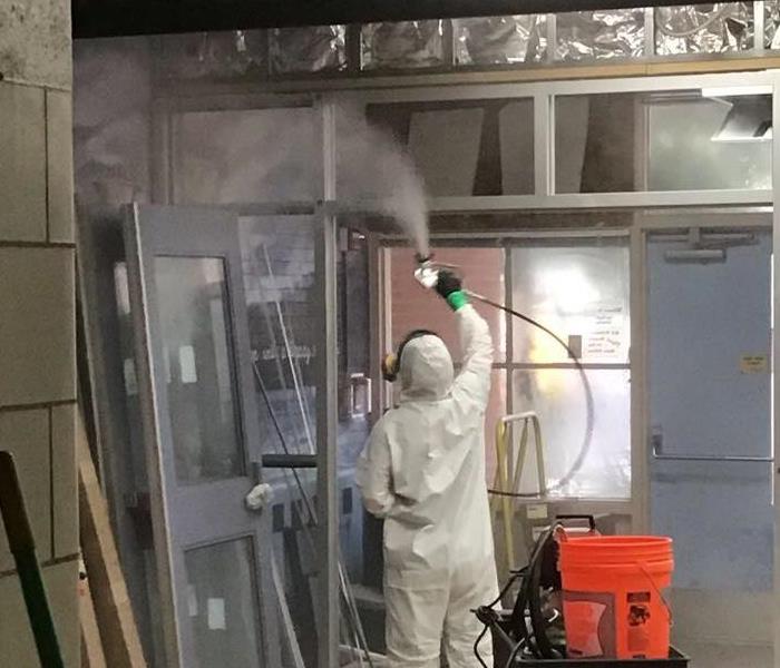 man wearing ppe cleaning